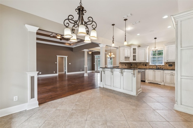 22924 County Road 223, Arp, TX 75750 - kitchen with a chandelier, dark countertops, tasteful backsplash, light tile patterned floors, and a sink