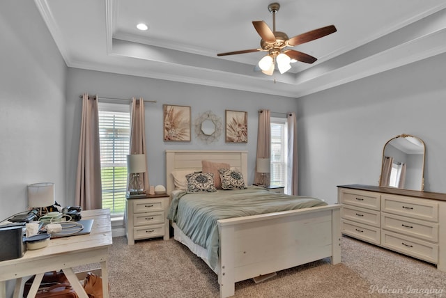 bedroom featuring light carpet, a tray ceiling, multiple windows, crown molding, and recessed lighting