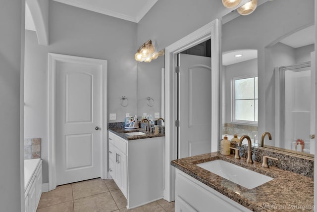 bathroom featuring tile patterned flooring, two vanities, and crown molding