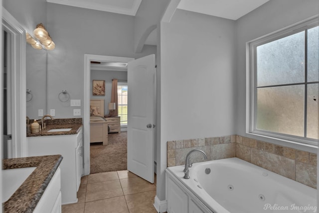 ensuite bathroom featuring vanity, tile patterned floors, and a jetted tub