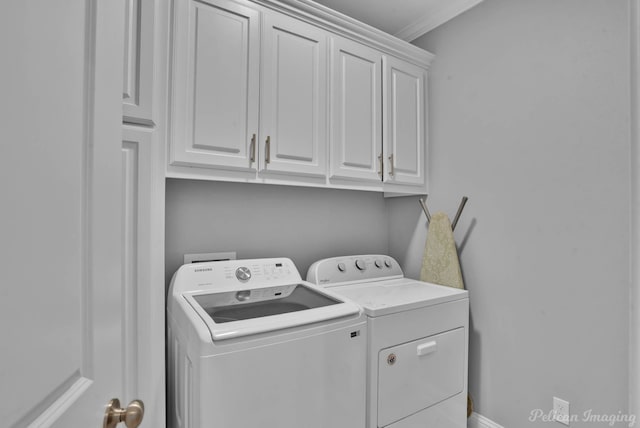laundry area featuring independent washer and dryer, cabinet space, and ornamental molding