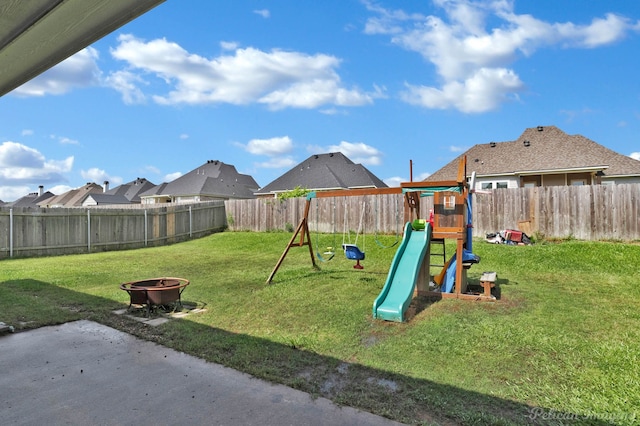 view of jungle gym featuring an outdoor fire pit and a residential view