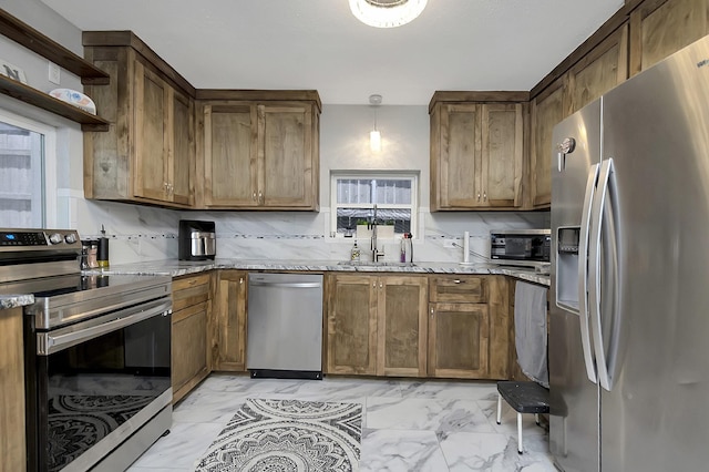 14070 Rucker St, Azle, TX 76020 - kitchen with stainless steel appliances, light marble finish flooring, a sink, light stone countertops, and brown cabinets