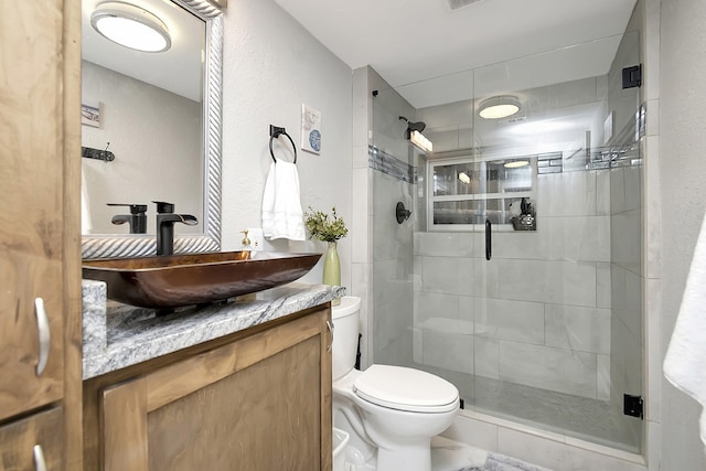 14070 Rucker St, Azle, TX 76020 - bathroom featuring toilet, a shower stall, vanity, and a textured wall