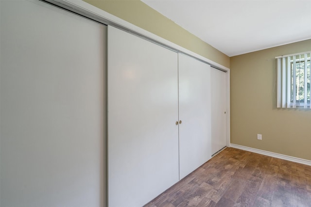 1621 Baseball Loop, Diana, TX 75640 - unfurnished bedroom featuring wood finished floors, a closet, and baseboards