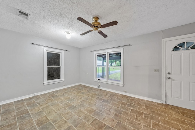 1621 Baseball Loop, Diana, TX 75640 - unfurnished room with a ceiling fan, a textured ceiling, and baseboards