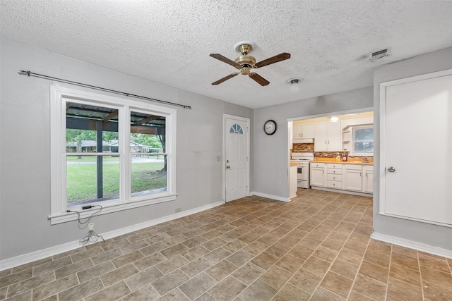 1621 Baseball Loop, Diana, TX 75640 - entryway featuring ceiling fan, a textured ceiling, baseboards, and light tile patterned flooring