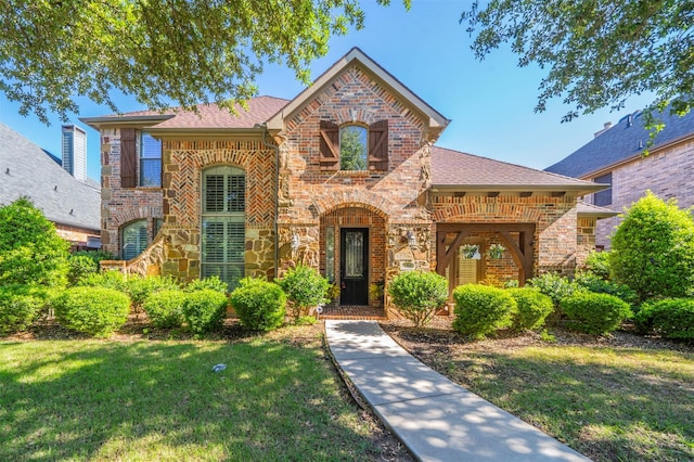 1364 Aubrey Ln, Frisco, TX 75033 - view of front of house with brick siding, a front yard, and a shingled roof