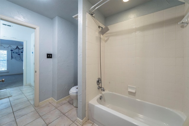1364 Aubrey Ln, Frisco, TX 75033 - bathroom featuring tile patterned flooring, toilet,  shower combination, a textured wall, and baseboards