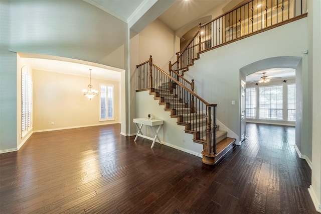 1364 Aubrey Ln, Frisco, TX 75033 - stairs with arched walkways, healthy amount of natural light, wood-type flooring, a towering ceiling, and a chandelier