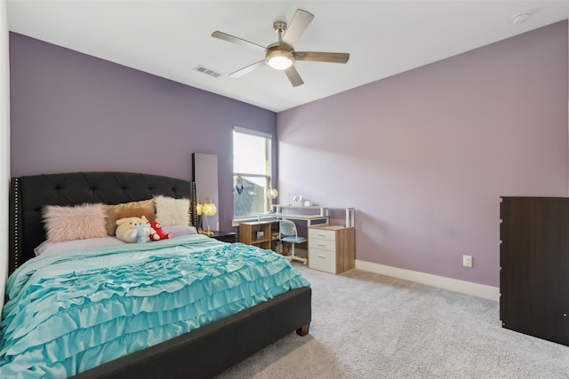 bedroom featuring light colored carpet, a ceiling fan, and baseboards
