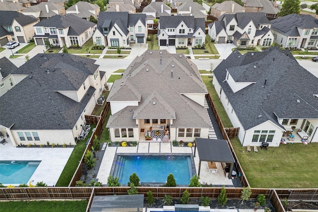 view of pool featuring a fenced backyard, a residential view, and a patio
