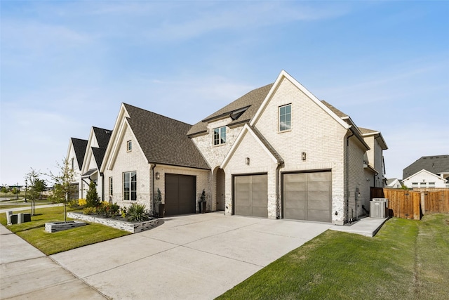 view of front of property with brick siding, driveway, a shingled roof, a garage, and cooling unit