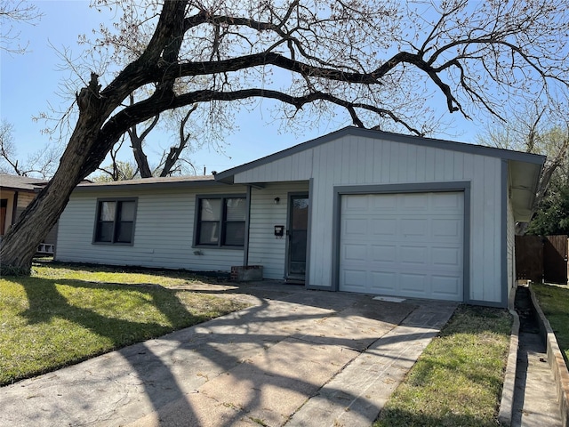 ranch-style house with driveway, a front yard, and an attached garage