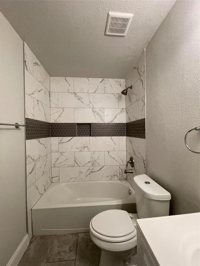 full bathroom featuring a textured ceiling, toilet, tub / shower combination, vanity, and baseboards