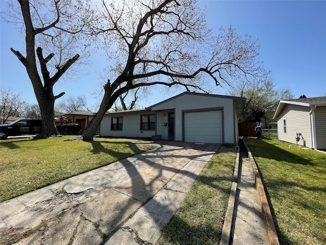 ranch-style home featuring a garage, driveway, and a front lawn