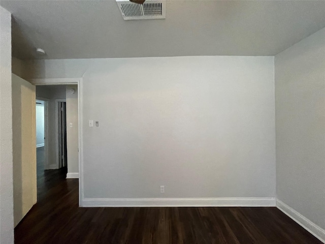 empty room with baseboards and dark wood finished floors