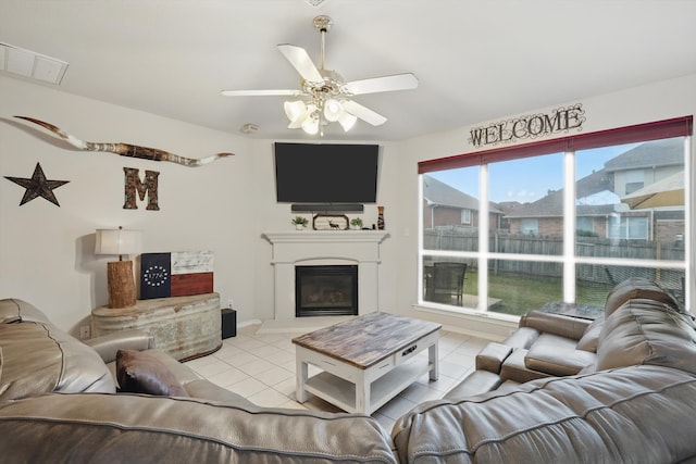 living room with arched walkways, ceiling fan, light tile patterned floors, and recessed lighting