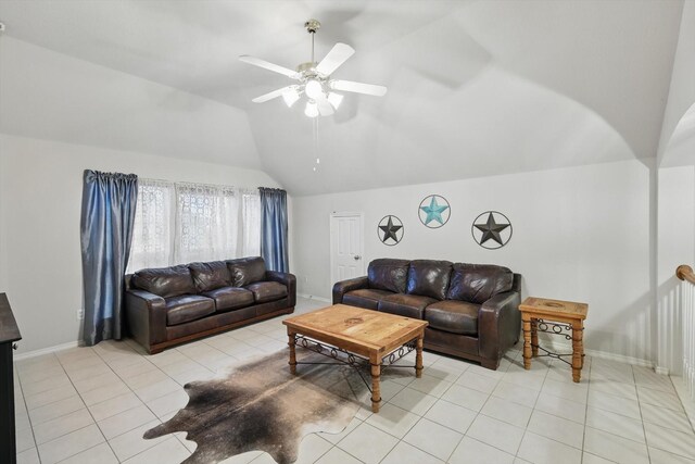 living room featuring ceiling fan, arched walkways, vaulted ceiling, and light tile patterned floors