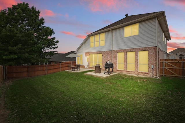 back of house featuring a patio and brick siding