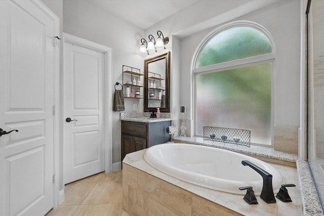 full bathroom featuring a bath, vanity, and tile patterned floors