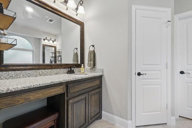 bathroom with vanity and baseboards