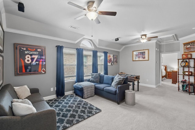 carpeted living area featuring attic access, ceiling fan, ornamental molding, and baseboards