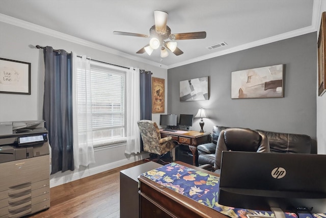 home office featuring wood finished floors, a ceiling fan, baseboards, and crown molding