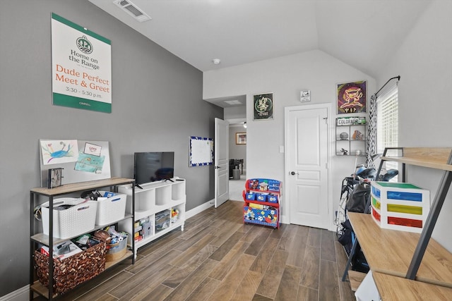 rec room with wood finished floors, lofted ceiling, and baseboards