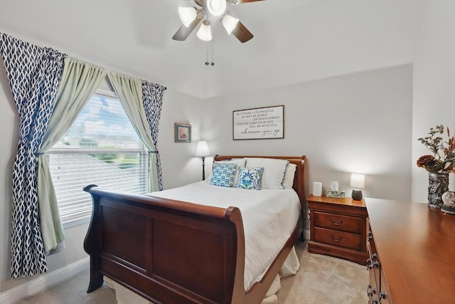 bedroom with light carpet, ceiling fan, and baseboards
