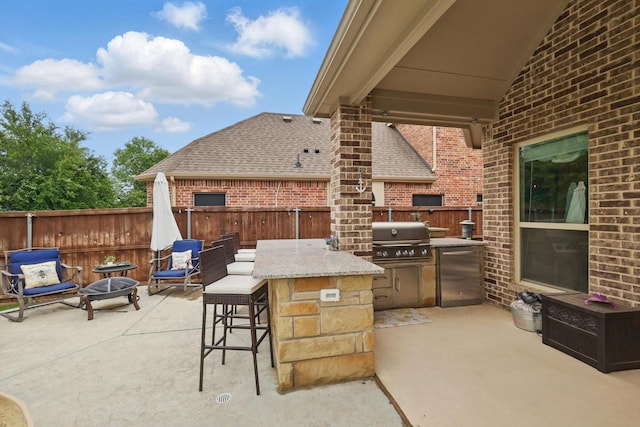 view of patio with a grill, a fenced backyard, and area for grilling
