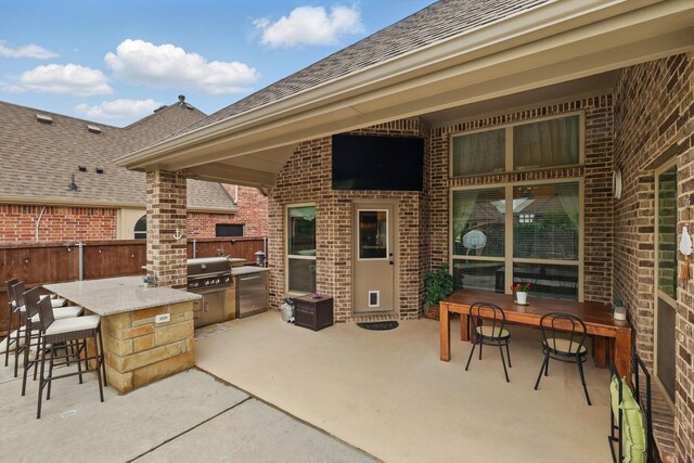 view of patio with area for grilling and fence