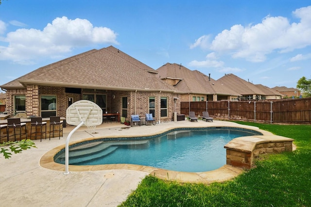 view of pool with a fenced backyard and a patio