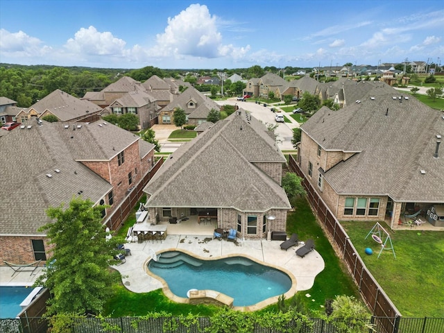 aerial perspective of suburban area featuring a pool area