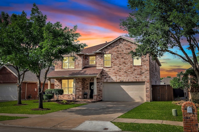 traditional home with concrete driveway, an attached garage, brick siding, and roof with shingles