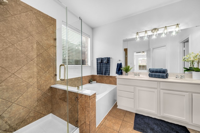 full bath featuring a garden tub, double vanity, a stall shower, and tile patterned flooring