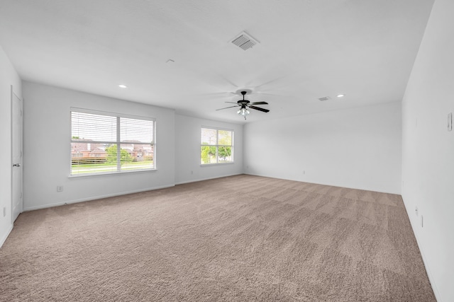 empty room with carpet flooring, recessed lighting, a ceiling fan, and baseboards