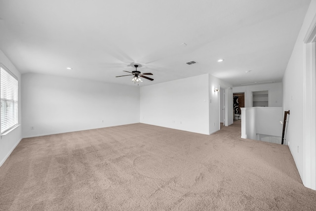 unfurnished room with light colored carpet, a ceiling fan, and recessed lighting