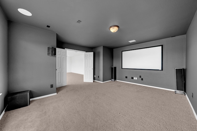home theater room featuring carpet flooring and baseboards