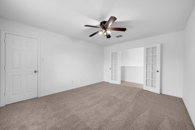 unfurnished bedroom with french doors, carpet flooring, baseboards, and ceiling fan