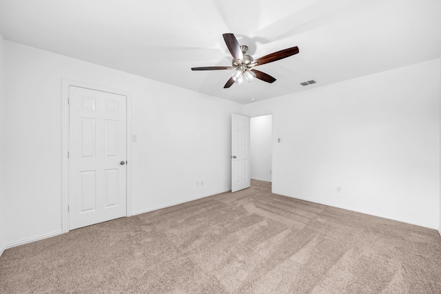 unfurnished bedroom with light colored carpet, baseboards, and ceiling fan