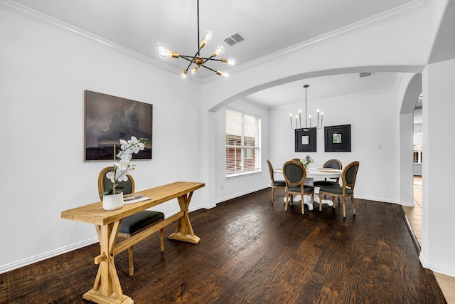 dining room featuring a chandelier, arched walkways, crown molding, wood finished floors, and baseboards