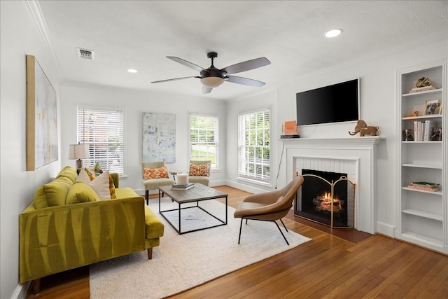 3501 Bristol Rd, Fort Worth, TX 76107 - living area featuring wood finished floors, a fireplace, ornamental molding, built in features, and ceiling fan