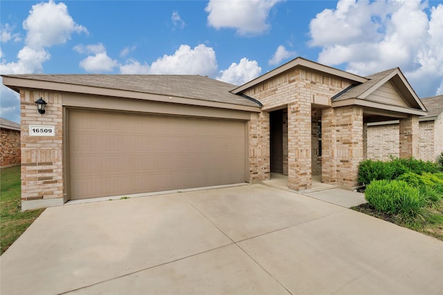 16509 Portage St, Justin, TX 76247 - ranch-style house with driveway, brick siding, and an attached garage