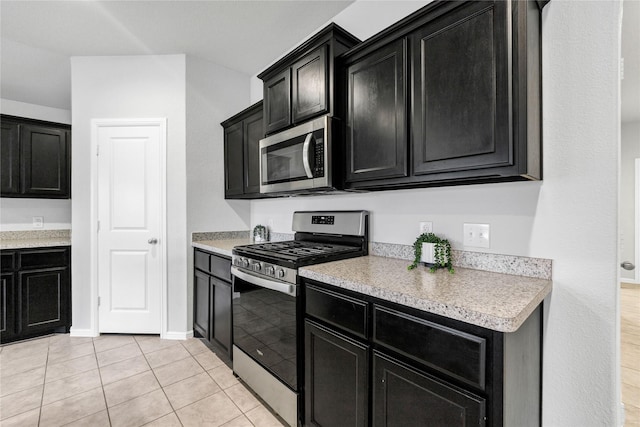 16509 Portage St, Justin, TX 76247 - kitchen with appliances with stainless steel finishes, dark cabinetry, and light countertops