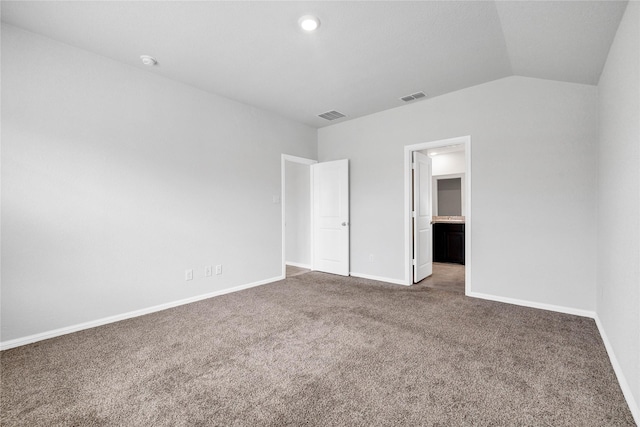16509 Portage St, Justin, TX 76247 - unfurnished bedroom with carpet, baseboards, lofted ceiling, and ensuite bath