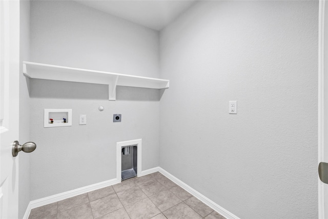 16509 Portage St, Justin, TX 76247 - laundry room with electric dryer hookup, hookup for a gas dryer, washer hookup, baseboards, and light tile patterned flooring