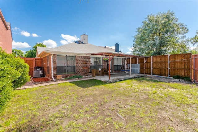 3841 Beaumont Ln, Plano, TX 75023 - rear view of property with brick siding, a patio area, cooling unit, and a chimney