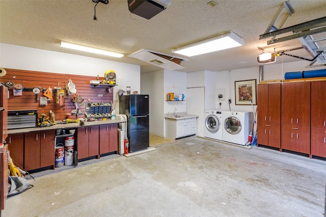 3841 Beaumont Ln, Plano, TX 75023 - garage featuring washer and clothes dryer, a workshop area, a sink, freestanding refrigerator, and a garage door opener