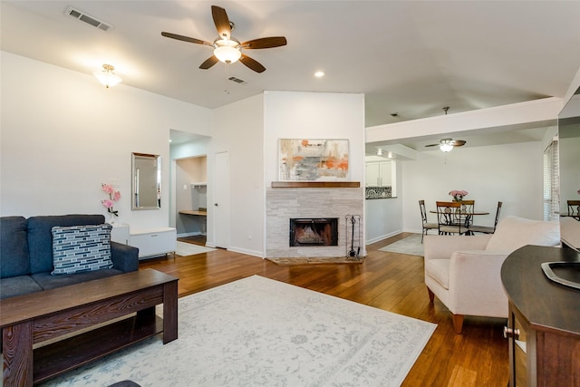 3841 Beaumont Ln, Plano, TX 75023 - living room with ceiling fan, a tile fireplace, dark wood-style floors, and recessed lighting